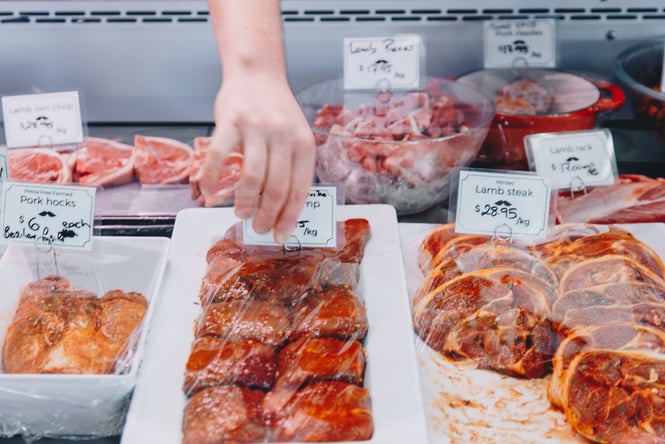 Wrapped raw meat in a deli counter.
