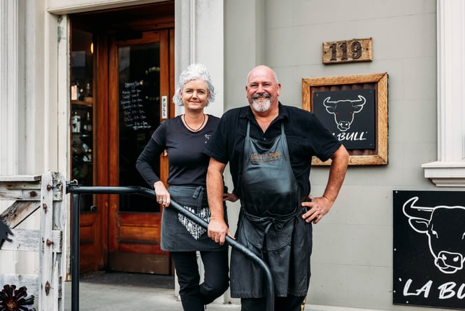 A man and woman smiling for the camera outside La Bull in Rangitikei.
