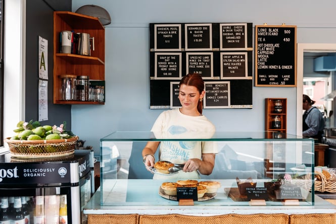 A staff member working behind the counter at Relish Cafe.