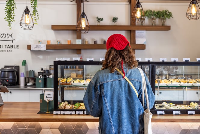 A customer looking at the sushi cabinet at Nori Table.