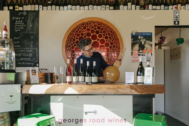 A man behind a bar at Georges Road.