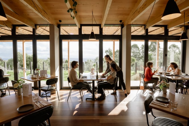 Customers being served a table in a restaurant.