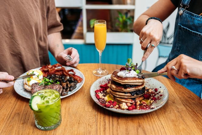 People tucking into plates of brunch.
