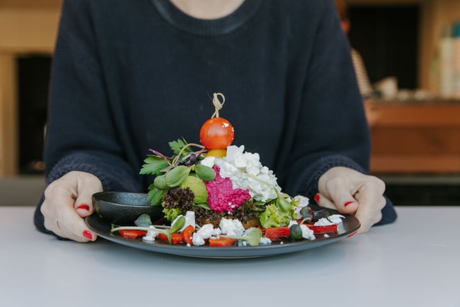 Toast pilled high with vegetables and feta cheese.