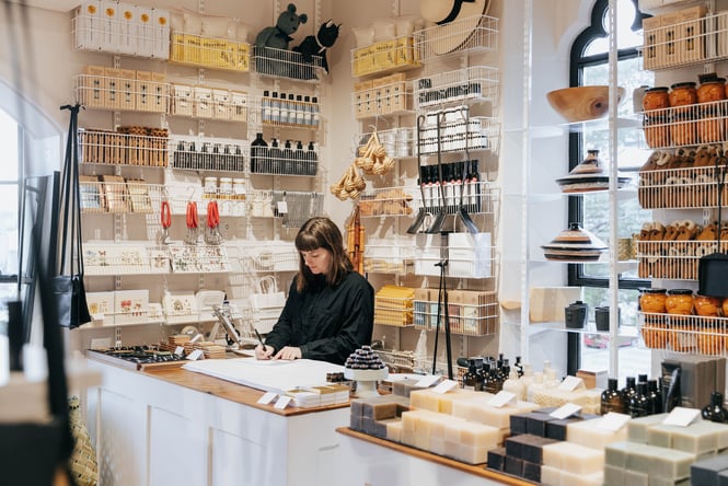 A woman working behind the counter at Frances Nation.