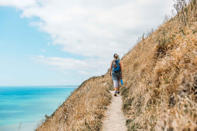 A woman walking the Paekākāriki Escarpment Track.