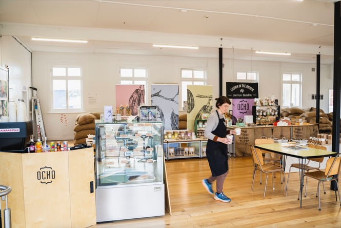 A staff member walking inside OCHO Dunedin.