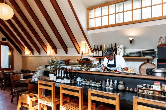 A man working behind a bar inside Kappa.