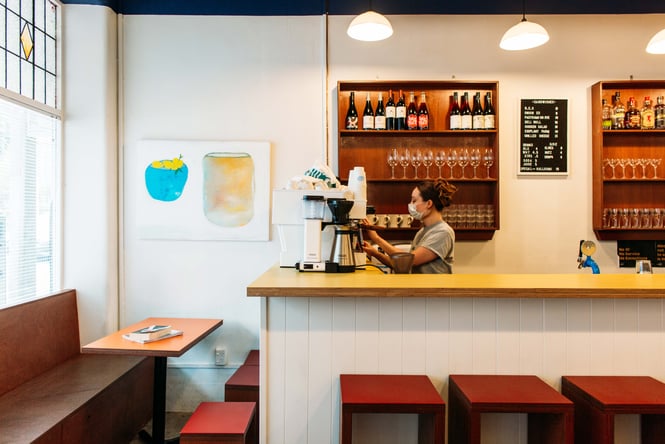 A staff member working behind the counter at Romeos.