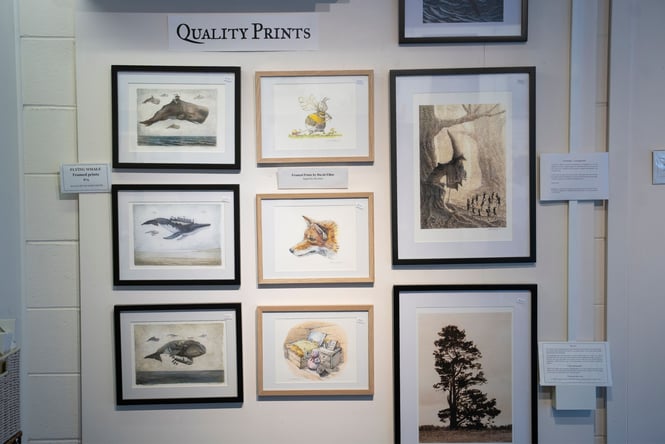 Illustrations of whales and foxes on a wall.