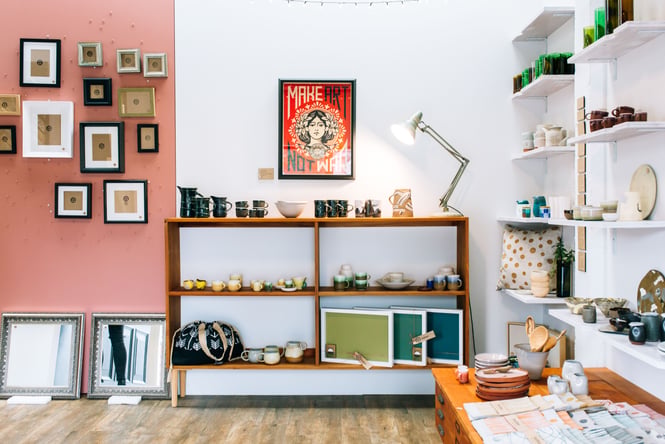 Items for sale on floating shelves inside a brightly lit shop.