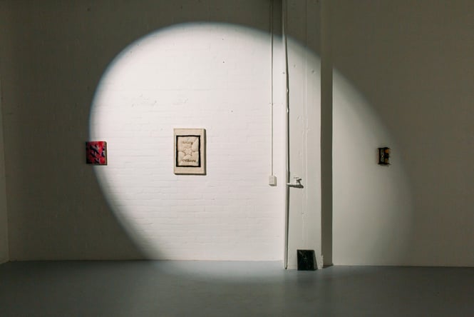 A light shining on art at Play Station.