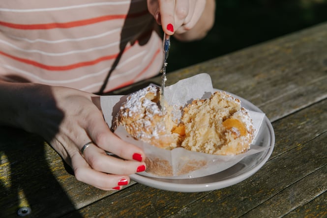 A close up of an apricot muffin cut in half.