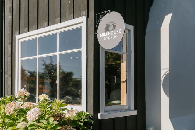 A little black and white circular sign on a wall.