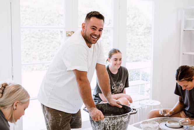 Sam and his customers at a pottery making course.