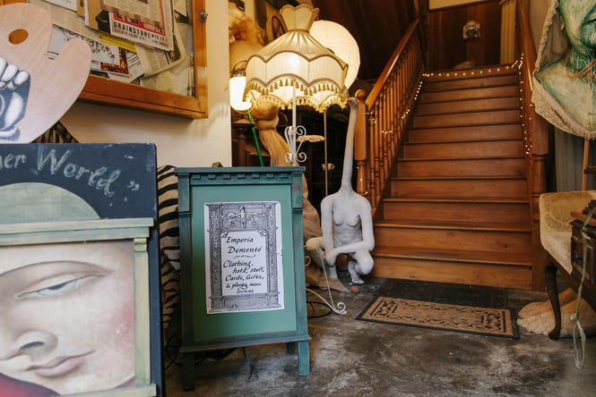 A sign and staircase leading to Grainstore Gallery.