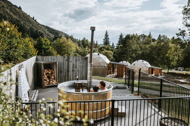 Two people in a spa outdoors.