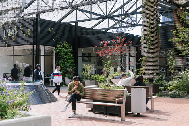 People sitting on outdoors tables in Britomart.