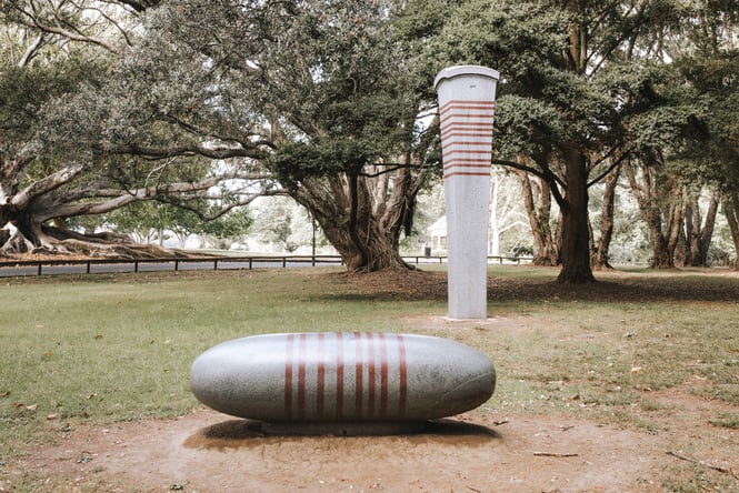 Two sculptures on grass.