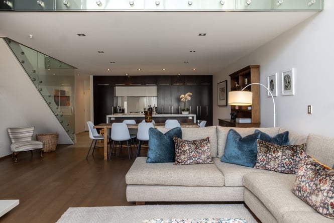 Living room area with the kitchen behind.
