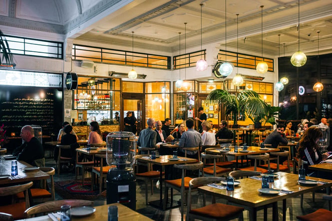 People dining under dim lights at Gemmayze Street in Auckland.