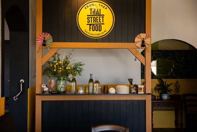 The blue and black interior of Krung Thep Thai Street Food in Ashburton.