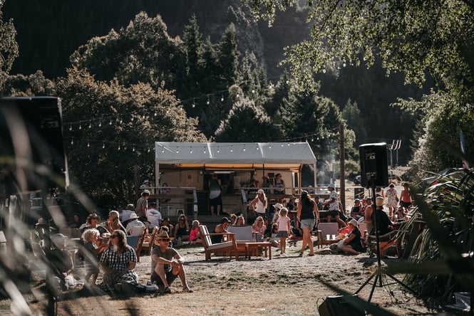 Young people having a party on the edge of a lake.