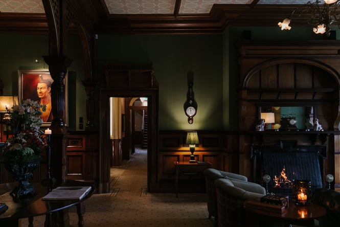 Seating inside a darkly lit Otahuna Lodge.