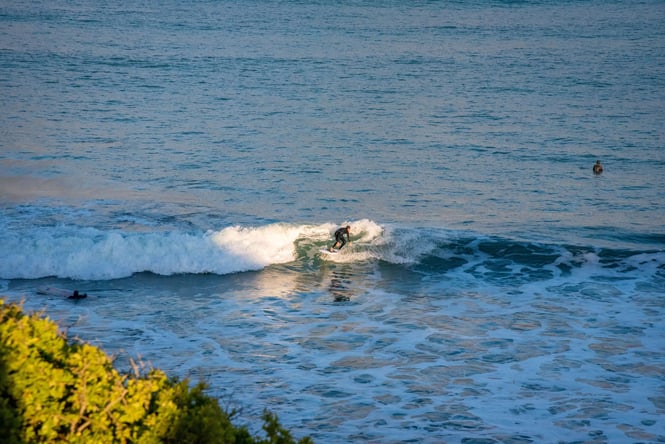 A man surfing the waves at Kakanui Beach.