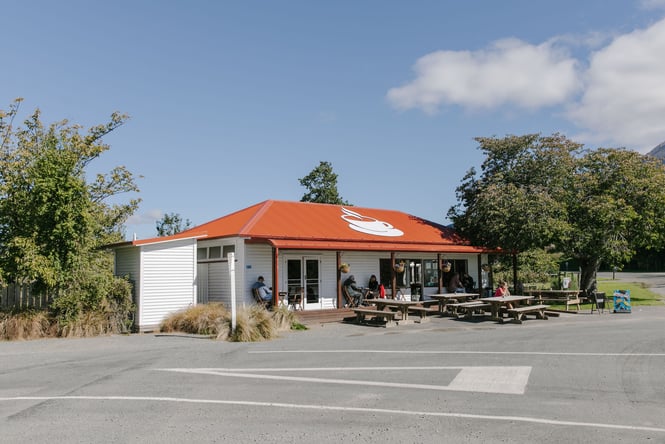 The white and red exterior of The Staveley Store on a sunny day.