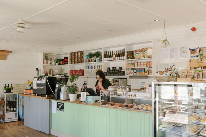 A staff member standing behind the cafe counter.
