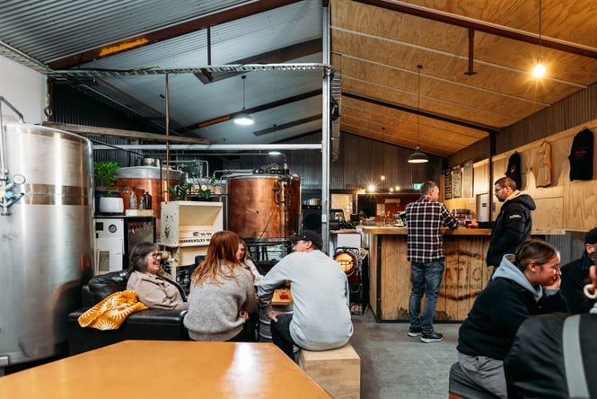 People dining inside a brewery.