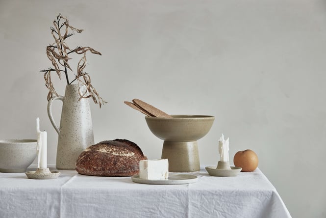 Salad Days ceramic bowls and plates on a table with a white table cloth.