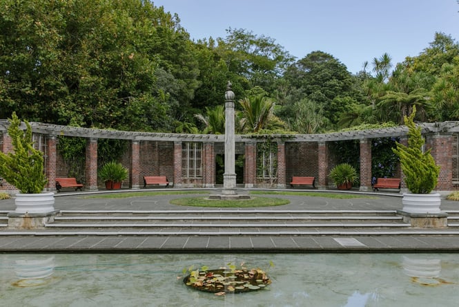 Park benches encircling a fountain at Domain Wintergardens in Auckland