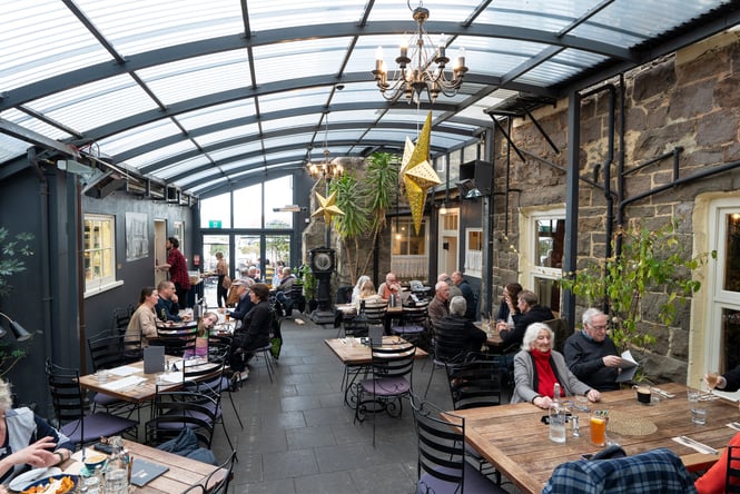 People dining inside a bar.