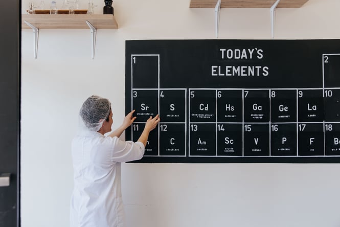 A staff member adjusting the black and white wall menu.