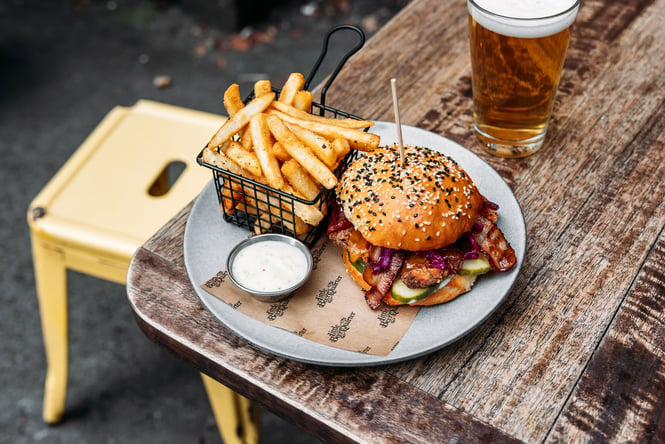 A burger and fries on a plate.