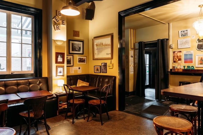The cosy yellow interior of Little Beer Quarter Wellington.