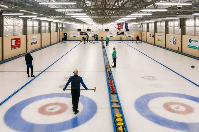 A group of people curling.