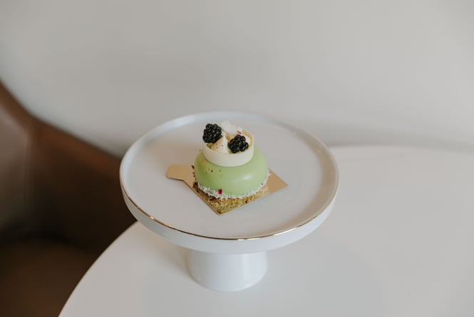 A green dessert decorated with berries.