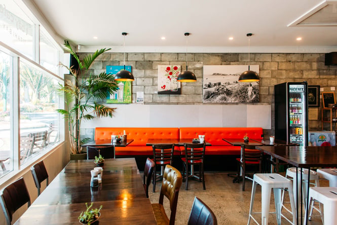 The red and brown interior of T Bay cafe in Porirua.
