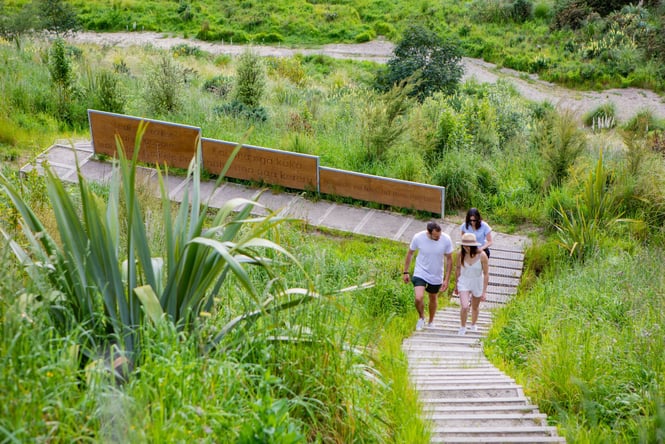 People walking up the Stairway of Tane on a sunny day.