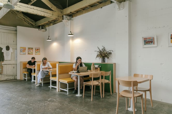 People sitting in diner-style booths at Grizzly Baked Goods