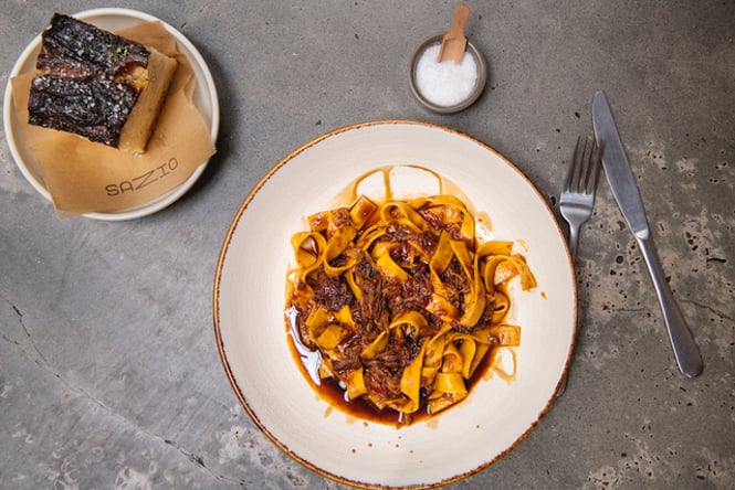Close up of a plate of pasta on a table at Sazio.