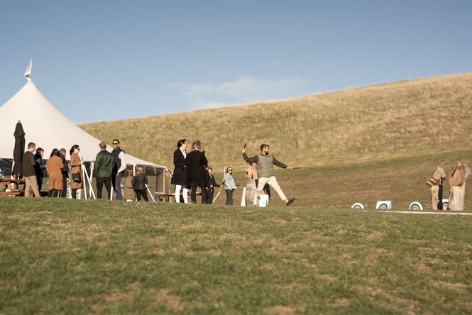People throwing things on grass.