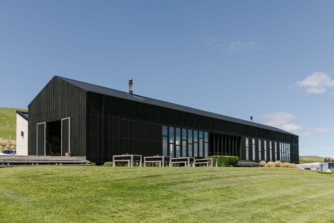 The black exterior of Black Estate on a sunny day.
