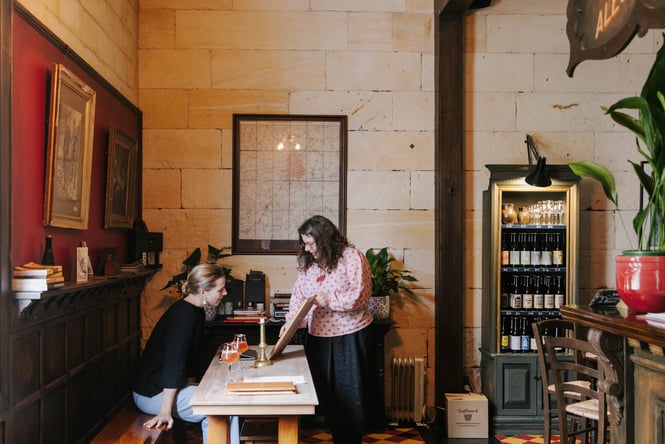 A woman talking to a customer inside Craftwork in Oamaru.