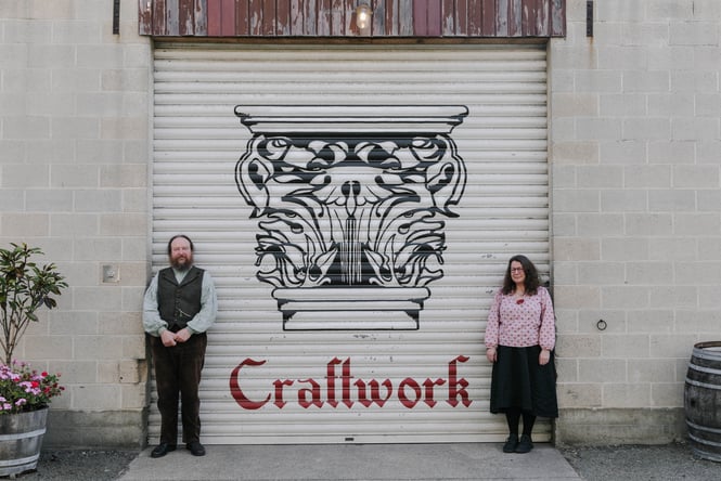 A man and woman standing outside a building in Oamaru.