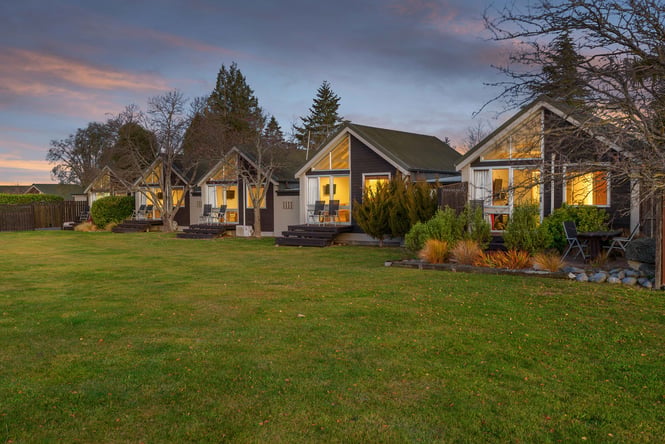 Apartments lined up along lawn.