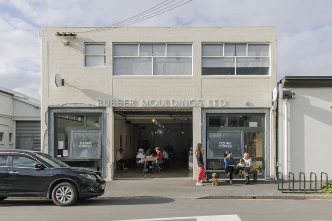 Exterior of Ozone Coffee in Christchurch with people standing outside with dog